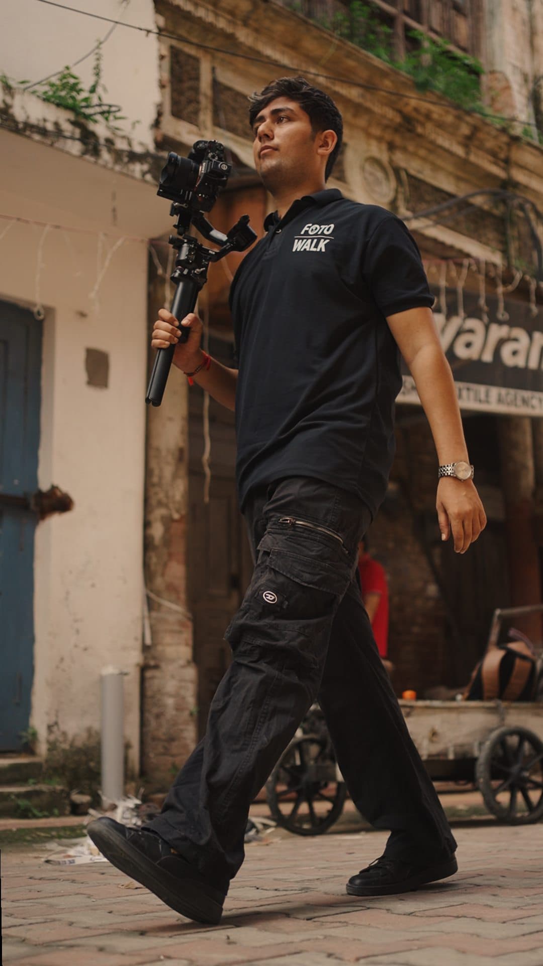 Jaigosh, FotoWalk's founder, walking through an old-city street with a gimbal-mounted camera